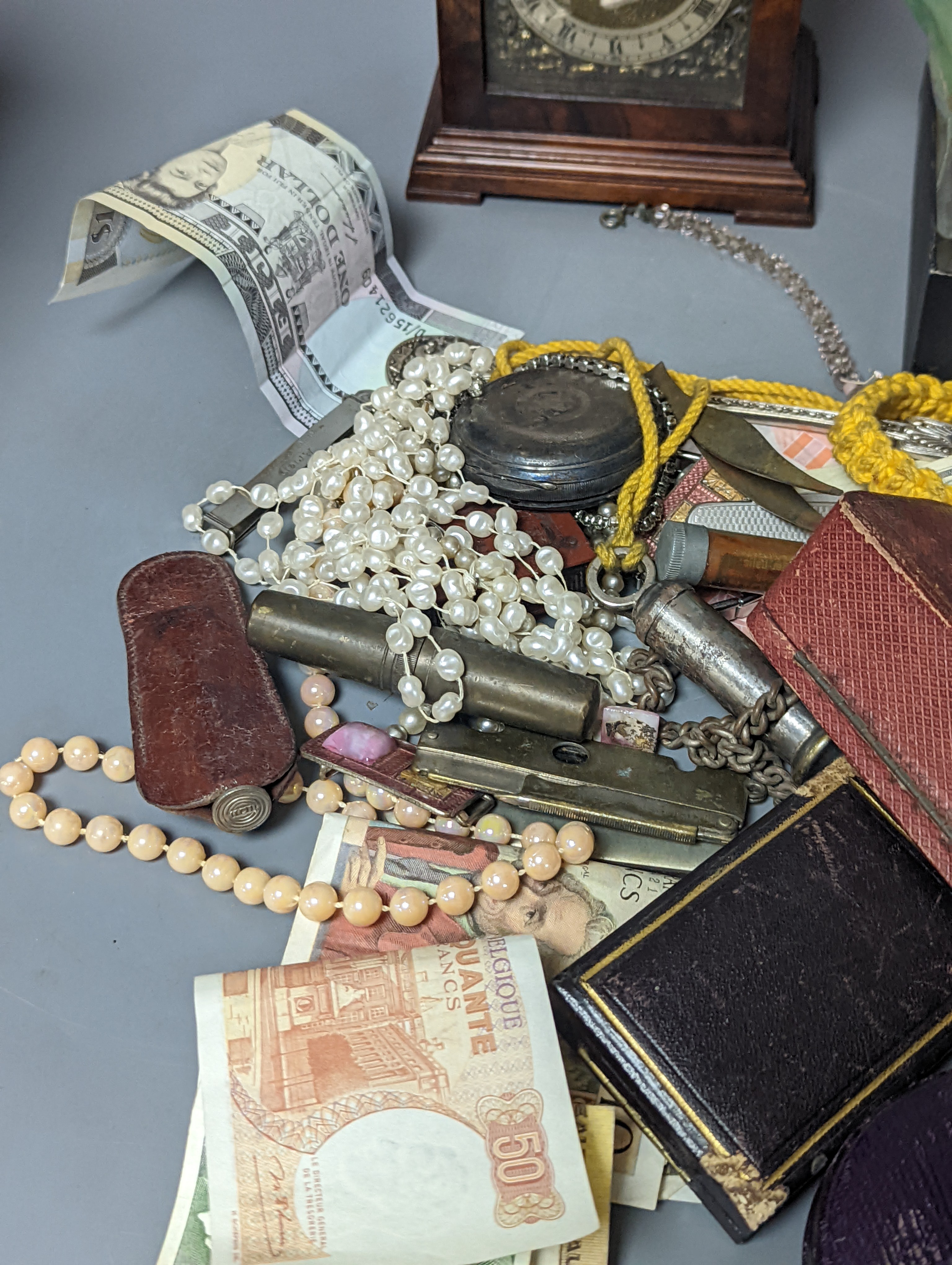 A pair of silver spoons, a small timepiece, assorted coinage and sundries